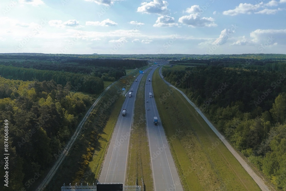 Obraz premium Highway traffic through forested European region