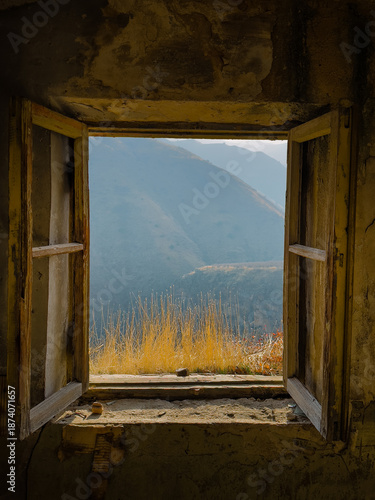 Picturesque view of mountain village from open window of rural house on cloudy day in Yerevan, Armenia. High quality photo