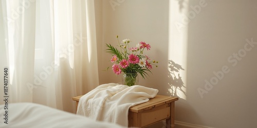 Decorative towel with flower motifs draped by a window, ideal for interior styling or relaxation spaces