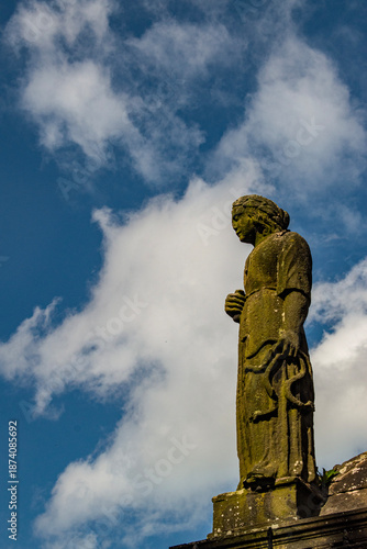 Edinburgh, Scotland: one of the moss covered statues in the Greyfriars Kirkyard, the graveyard surrounding Greyfriars Kirk in the Old Town, where burials have started since the late 16th century