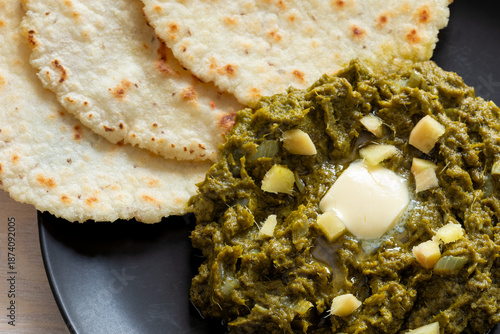 Tableau sur toile Close-up of mustard greens puree with butter, ginger, and cornmeal flatbreads on the second table