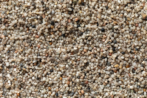 Close-up view of small, fine grains of pea gravel (2-3 mm) observed from an overhead perspective. 