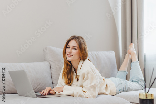 Freelance student works from home on laptop while studying in a comfortable living space during daytime hours