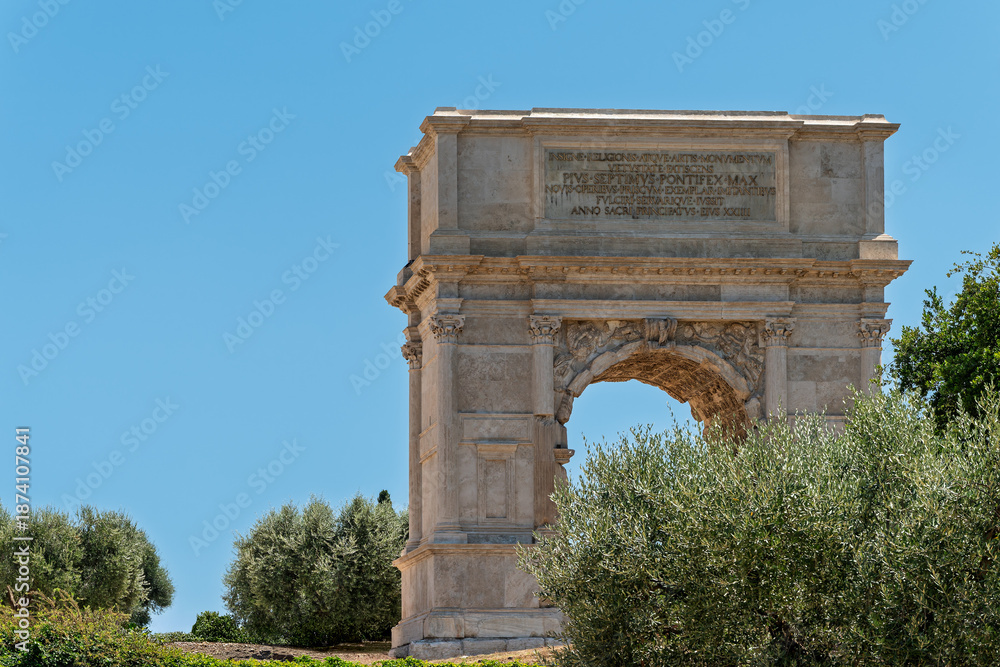 Fototapeta premium Italy - Rome - Arch of Titus - Ancient Roman triumphal arch with marble inscriptions and reliefs standing in the Roman Forum site.