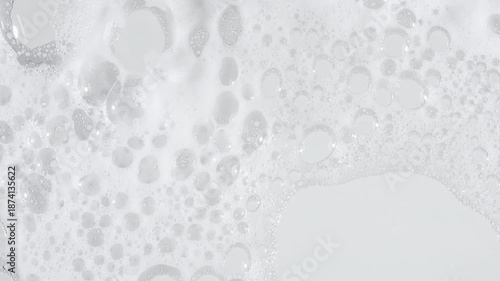 Bubbles of white soap foam. Moving Soap foam popping bubble on a white backdrop. Soap sud macro structure. Clean, cleaning concept, laundry, shower. . High quality 4k footage