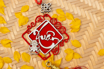 Lucky calligraphy Spring sign surrounded by yellow apricot blossoms on a traditional bamboo mat for Vietnamese Lunar New Year celebration