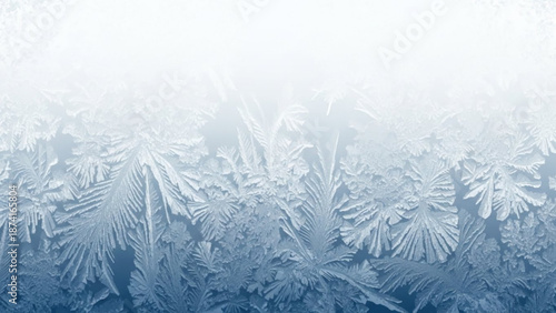 Intricate frost patterns on a windowpane create a mesmerizing display of crystalline structures in shades of blue and white with ice