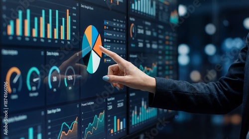 Hand touching transparent touchscreen dashboard with colorful pie chart and analytics displaying financial graphs and data visualization, dynamic business interface inspiring insight