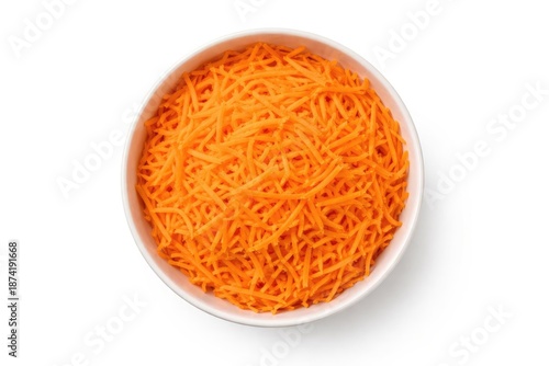 Top view of a bowl filled with finely shredded carrots against a clean white surface