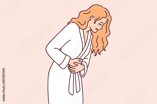 Young blonde woman in distress holding her stomach due to severe cramps. Concept of endometriosis or menstruation problems causing sharp pain in female body at home