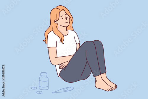 Sick girl feeling unwell with high temperature and resting near pills. Concept of common cold flu symptoms or viral infection causing fatigue and physical distress