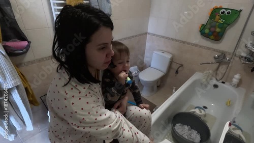 Mother and Child Brushing Teeth Together