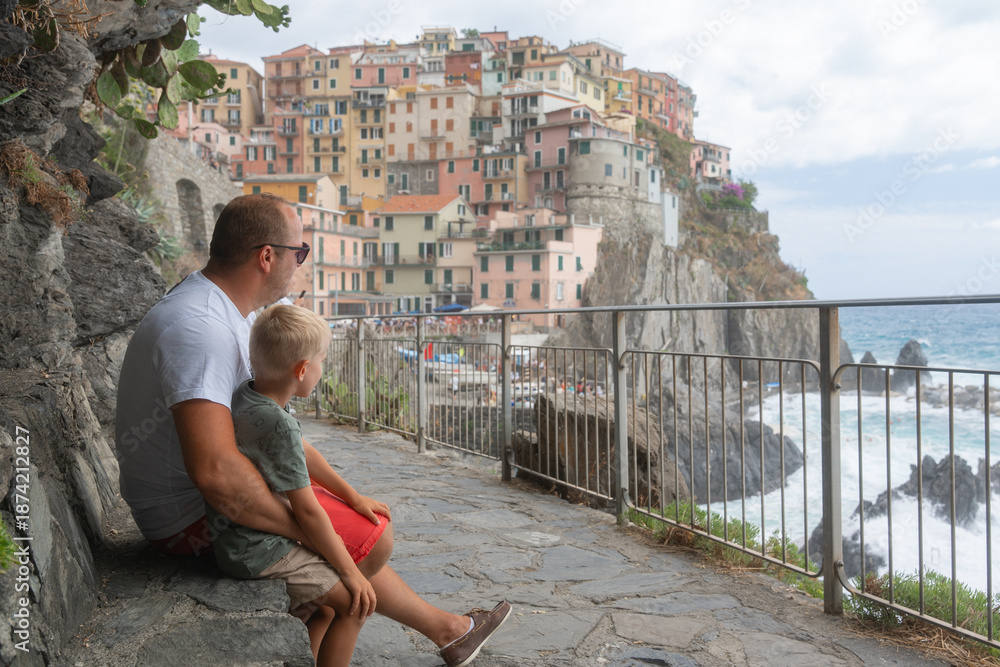 Fototapeta premium Father and Son Overlooking Coastal Town