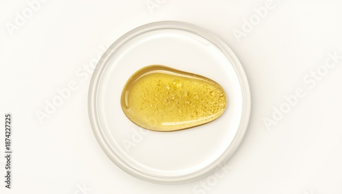 Drop of yellow oil with bub...
