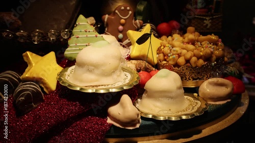 Traditional Italian Christmas sweets: honey-covered struffoli, white glazed cassatine, and gingerbread cookies on a festive red background. Warm, moody lighting for a gourmet holiday atmosphere.