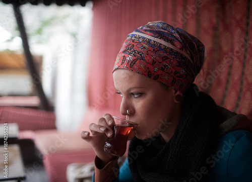 portrait of woman drink a tea in a street of Istanbul in winter  , turkey 
