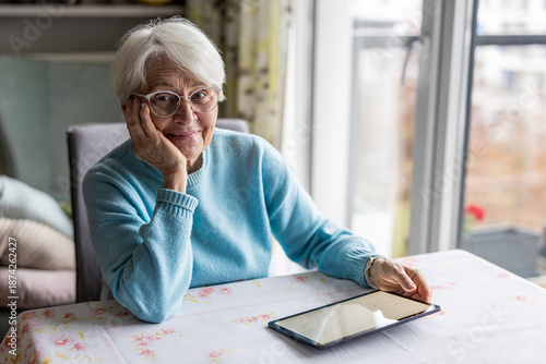 Senior woman using digital tablet at home
