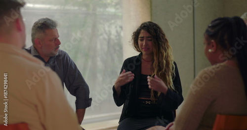 Bild auf Leinwand Young woman expressing deep pain through tears in group therapy session, surroun