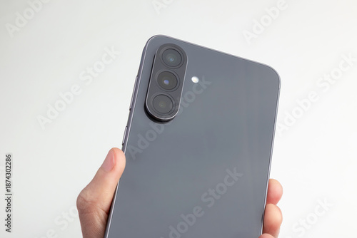 Sleek Smartphone Back With Triple Camera Held In Hand 