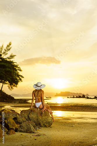 Woman on the tropical beach of Tubkaek in Krabi Thailand wearing an out of office straw hat