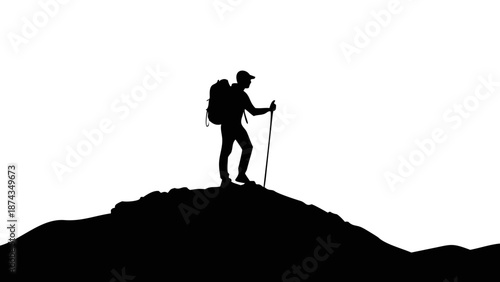Silhouette of a hiker with a backpack and trekking poles standing on top of a mountain peak, looking at the horizon, outdoor adventure concept.