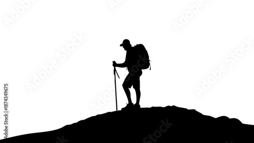 Silhouette of a hiker with a backpack and trekking poles standing on top of a mountain peak, looking at the horizon, outdoor adventure concept.