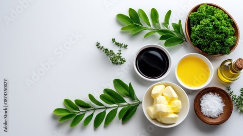Fresh Ingredients for Healthy Cooking with Olive Oil, Butter, Herbs, and Green Vegetables on a Clean White Background