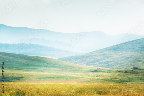 Green hills and mountains at sunny day. Abstract summer nature background