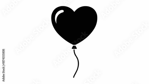 Black heart shaped balloon floating with a string.