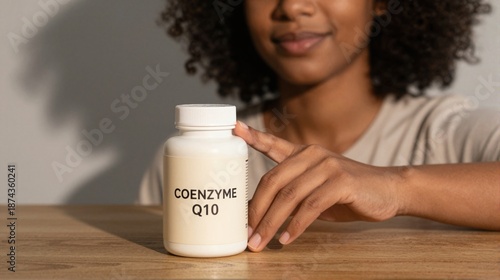 Woman Holding Coenzyme Q10 Supplement Bottle