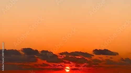 Beautiful golden sunset over the ocean horizon with vibrant orange clouds and water reflection