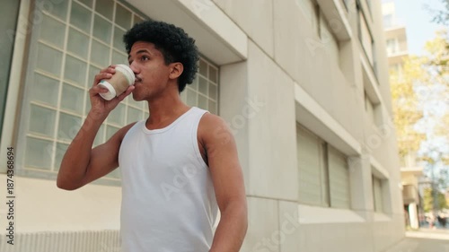 Young Man Sipping Coffee Outdoors