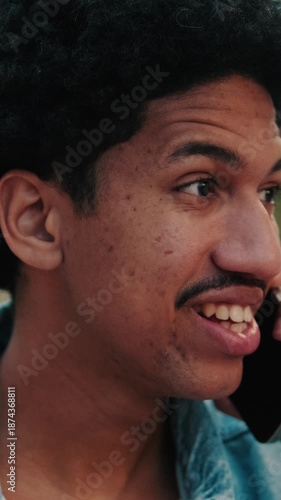 Happy Man Talking on Phone in City