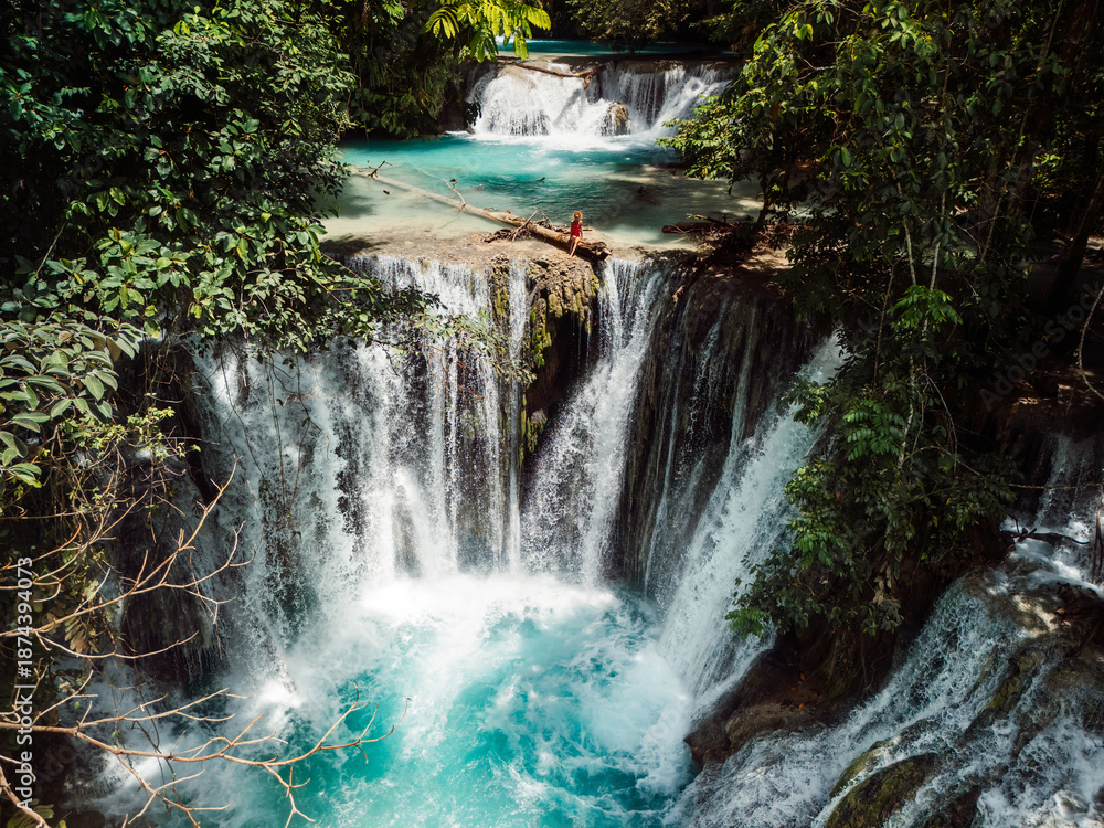 custom made wallpaper toronto digitalWoman in swimsuit on tropical waterfall with turquoise water, drone shot