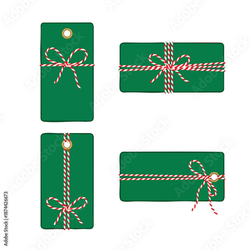 Festive green gift tags and rectangular boxes adorned with red and white striped twine on a clean white background for holiday presentation