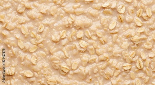 Detailed macro texture of creamy cooked oatmeal or hot cereal, showing warm, thick consistency, ideal for a uniform food background, gruel, thick, uniform