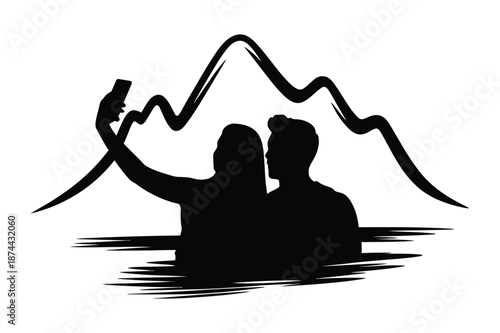 Silhouette of a couple taking a selfie with mountains