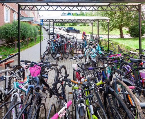 Bicycle parking full of bikes in modern residential area, sustainable urban transport. Visual abundance