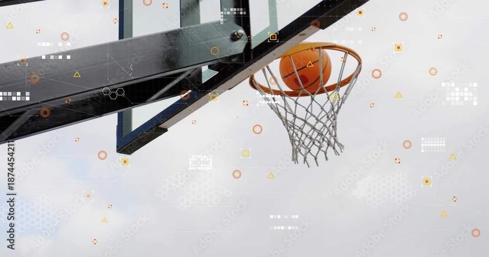 Obraz premium Sinking orange basketball through metal rim net support arm and icons at outdoor court, copy space
