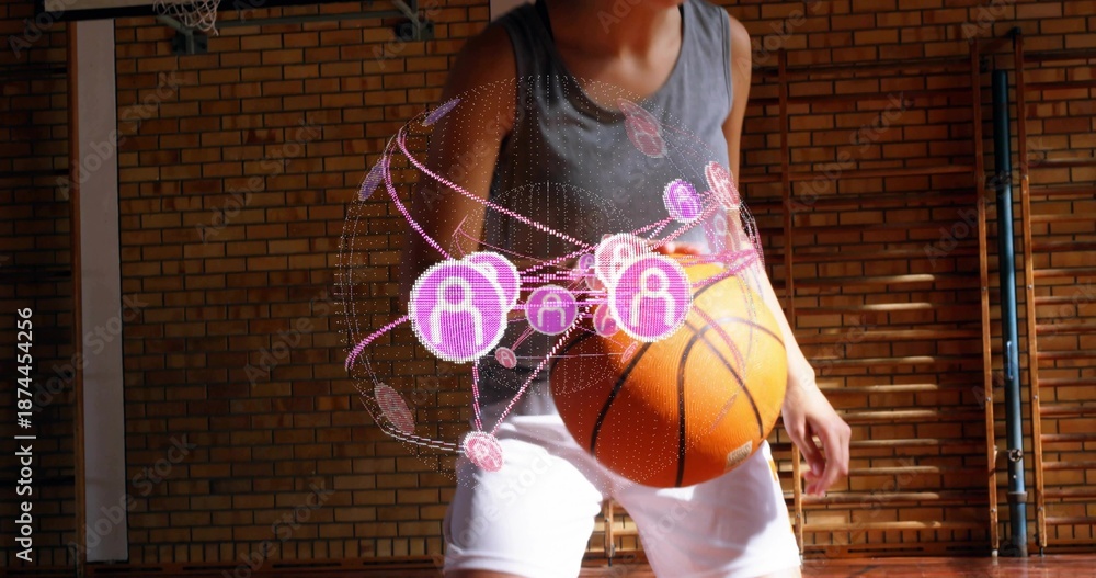 Fototapeta premium Holding basketball, teen wearing gray tank, white shorts crouching in gym with purple hologram