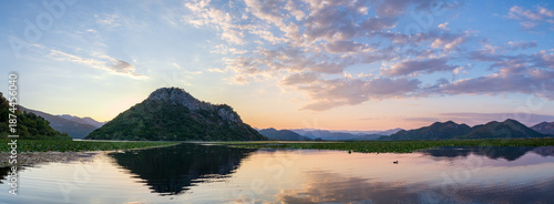 Panoramic sunset on the Skadar lake with mountains in the background. Montenegro.