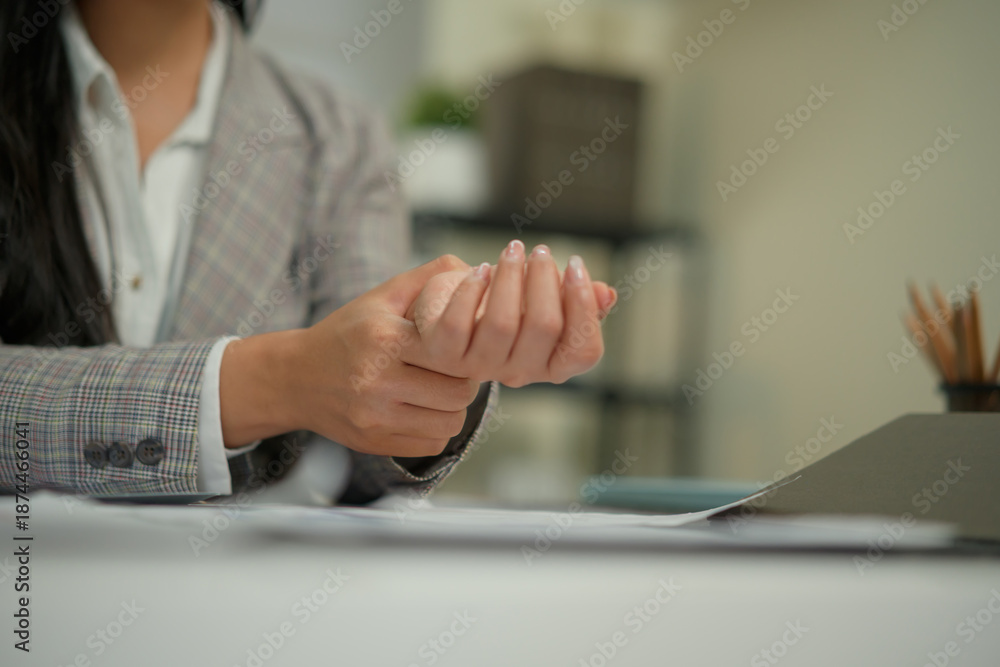 Fototapeta premium Close up businesswoman massage on his hand and arm for relief pain from hard office syndrome concept