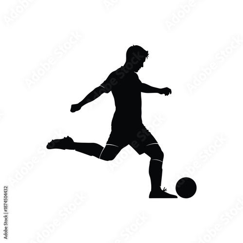 Silhouette of a soccer player kicking the ball