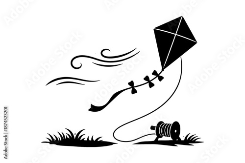 Silhouette kite flying in the wind with grass and roll