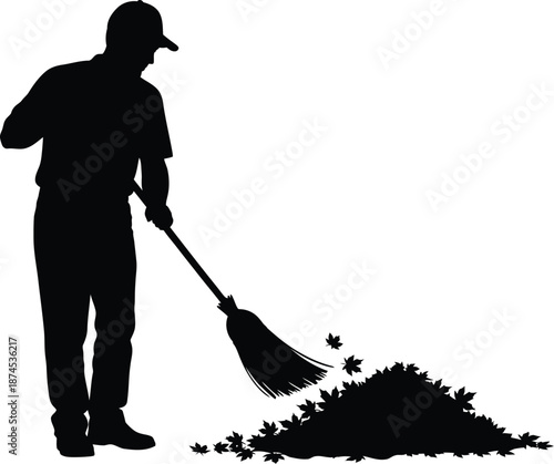 Man sweeping leaves with a broom a striking black silhouette