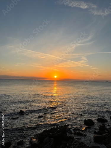 Sunset on a beach, with an orange colour. Very beautiful summer panorama. Golden hour.