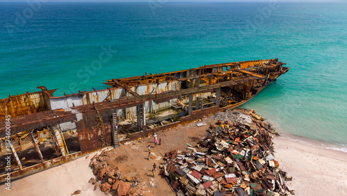 Foto Aerial View of Rusted Shipwreck on Sandy Beach