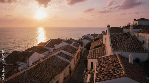 Aerial View of Coastal Town with Terracotta Roofs at Sunset