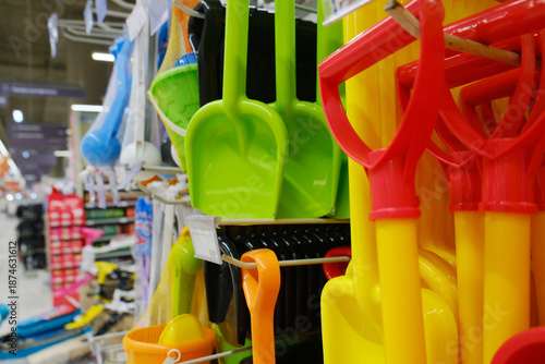 Various brightly colored plastic shovels and rackets are displayed on store shelves. Russia Moscow January 10, 2026