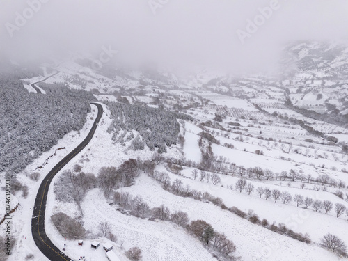 Odemis valley village and fields under winter snow